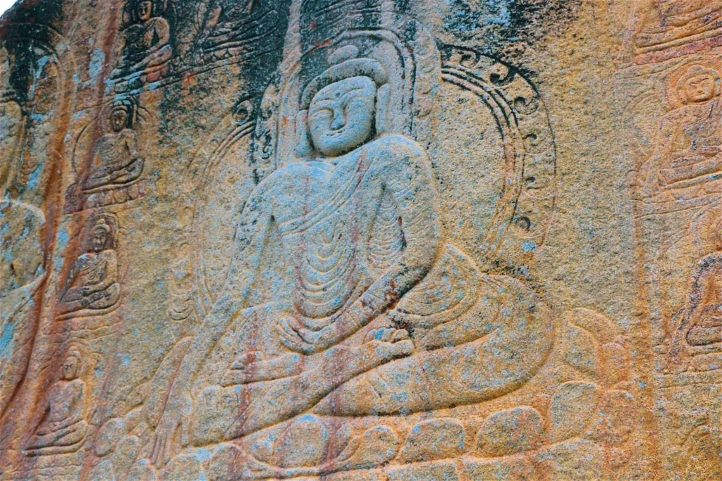 an image of budhha on rock sculpted by skardu's buddhist people