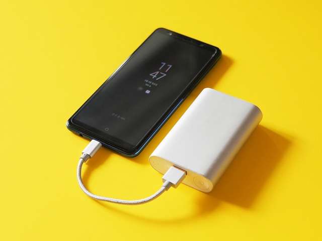 an image of power bank with mobile which is one of the best cool travel gadgets